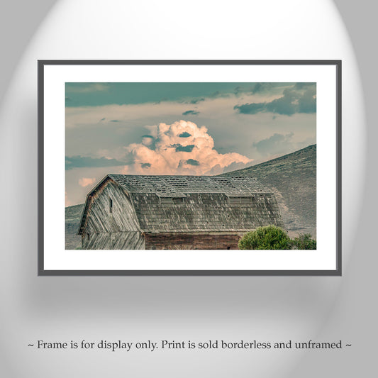 Framed print of a barn with a cloud formation in the sky on a gray wall. Old Barn Picture in Rustic Western Landscape with Stormy Sky | Northern California