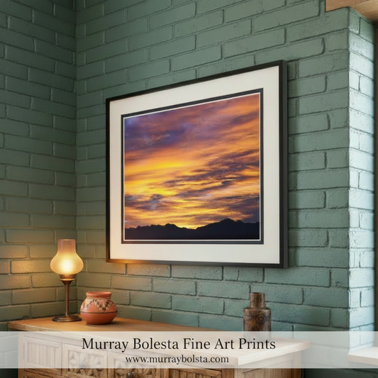 Sunset sky art with orange and purple hues over a mountain range by Murray Bolesta