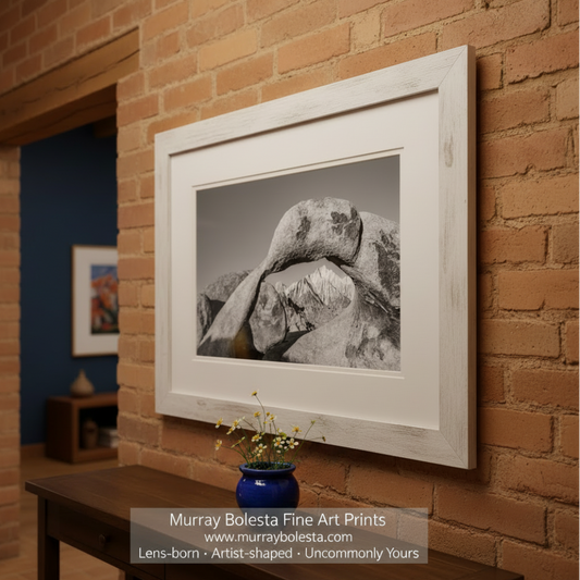 Black and white photo of a natural stone archway with mountains in the background. Alabama Hills Photograph as California Desert Western Landscape Wall Art in Black and White by Murray Bolesta