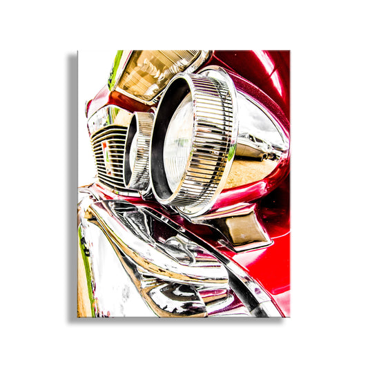 A close-up view of the front end of a red car, focusing on the headlights and grille. Chrysler Imperial Car Art Print as Vintage Wall Decor
