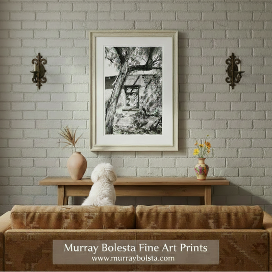 A black and white photograph of a dilapidated building with a partially broken window, surrounded by bare trees. Arizona Desert Adobe Ruins in Sepia Tone | Southwest Wall Decor by Murray Bolesta