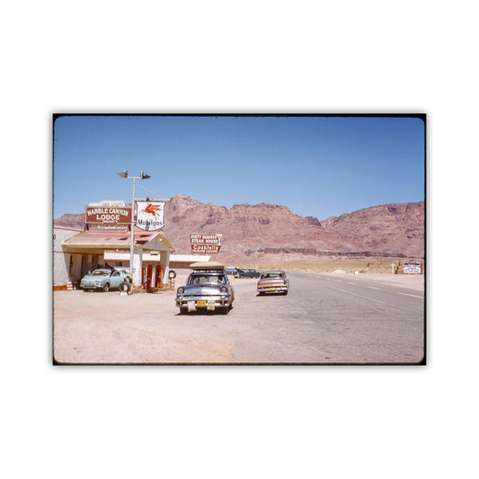 A vintage car is parked in front of a motel called "Marl Canyon Lodge" in a desert landscape with mountains in the background. Marble Canyon Arizona Grand Canyon Vintage Photo Print