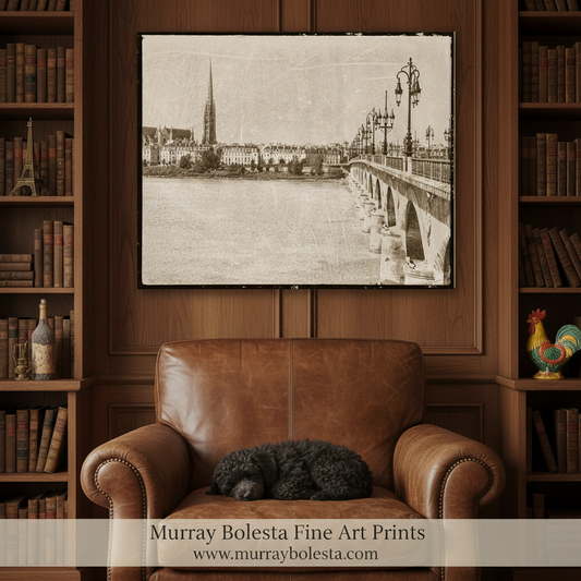 A black and white photograph of a bridge over a river, with a tall spire visible in the background. Bordeaux France Bridge Art Print | Pont de Pierre Vintage Decor by Murray Bolesta!