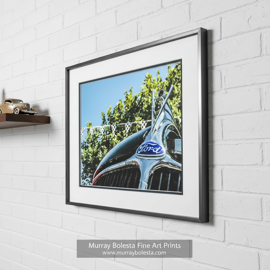 a close-up view of a classic Ford car's hood, featuring the iconic Ford emblem and grill. Vintage Ford V8 Old Car Picture as Wall Art by Murray Bolesta