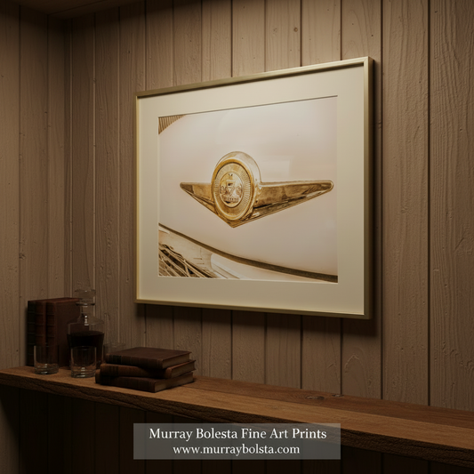 a close-up view of a classic car's emblem, featuring a golden emblem with a shield and a crown. Checker Car Art Print – Automotive Wall Decor by Murray Bolesta