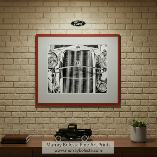 A close-up black and white photograph of the front grille and headlights of a classic car. Vintage Ford V8 Pickup Truck Art – Black & White Print by Murray Bolesta