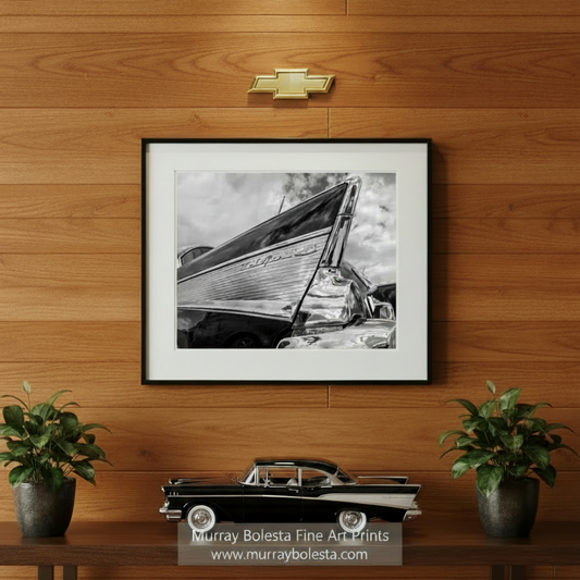 A black and white photograph of a chrome-plated Chevrolet Bel Air, showcasing its distinctive rounded front end and chrome trim. Chevy Bel Air Art Print | Classic Black & White Car Wall Decor by Murray Bolesta