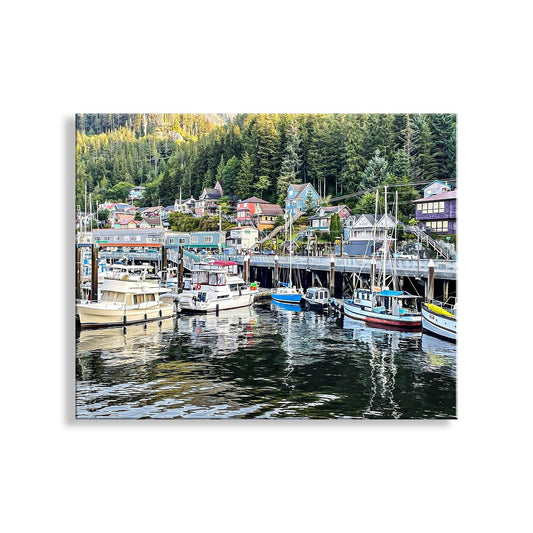 A scenic harbor with a variety of boats docked along the shore, surrounded by lush green trees and buildings. Ketchikan Alaska Fishing Boat Art with Harbor – Nautical Wall Print