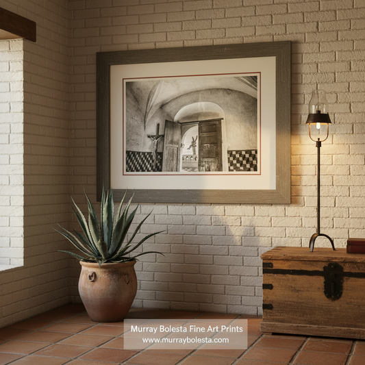 A black and white image of an interior space with a large wooden door, a cross, and a tiled wall. San Xavier Mission Black & White Art - Tucson Arizona Church Print by Murray Bolesta