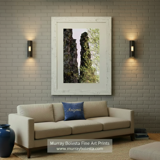 Two tall rock formations with greenery against a light purple sky. Mexico Border Wilderness Landscape Artwork with Desert Canyon Spire by Murray Bolesta