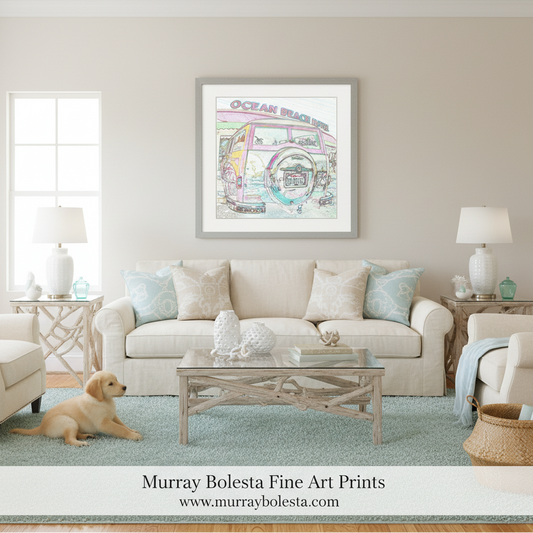 A framed art print featuring a colorful retro beach bus illustration with the words 'Ocean Beach' hangs on a beige wall above a cream sofa in a styled living room. A small golden puppy is lying on a light blue rug at the bottom left.