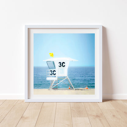 Framed artwork of a lifeguard stand on a beach with a blue sky. Lifeguard Tower Picture on San Diego California Beach | Square Picture