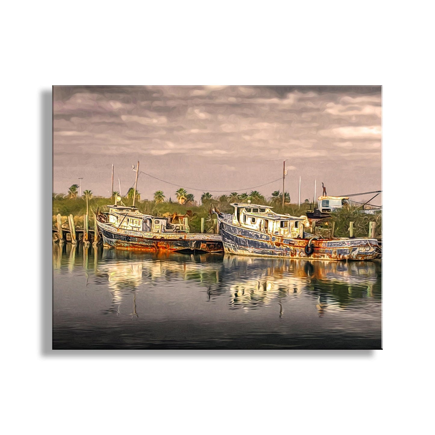 a serene harbor scene with two boats docked in the calm water, surrounded by lush greenery and a cloudy sky. South Padre Island Shrimp Boat Art – Vintage Nautical Print Texas