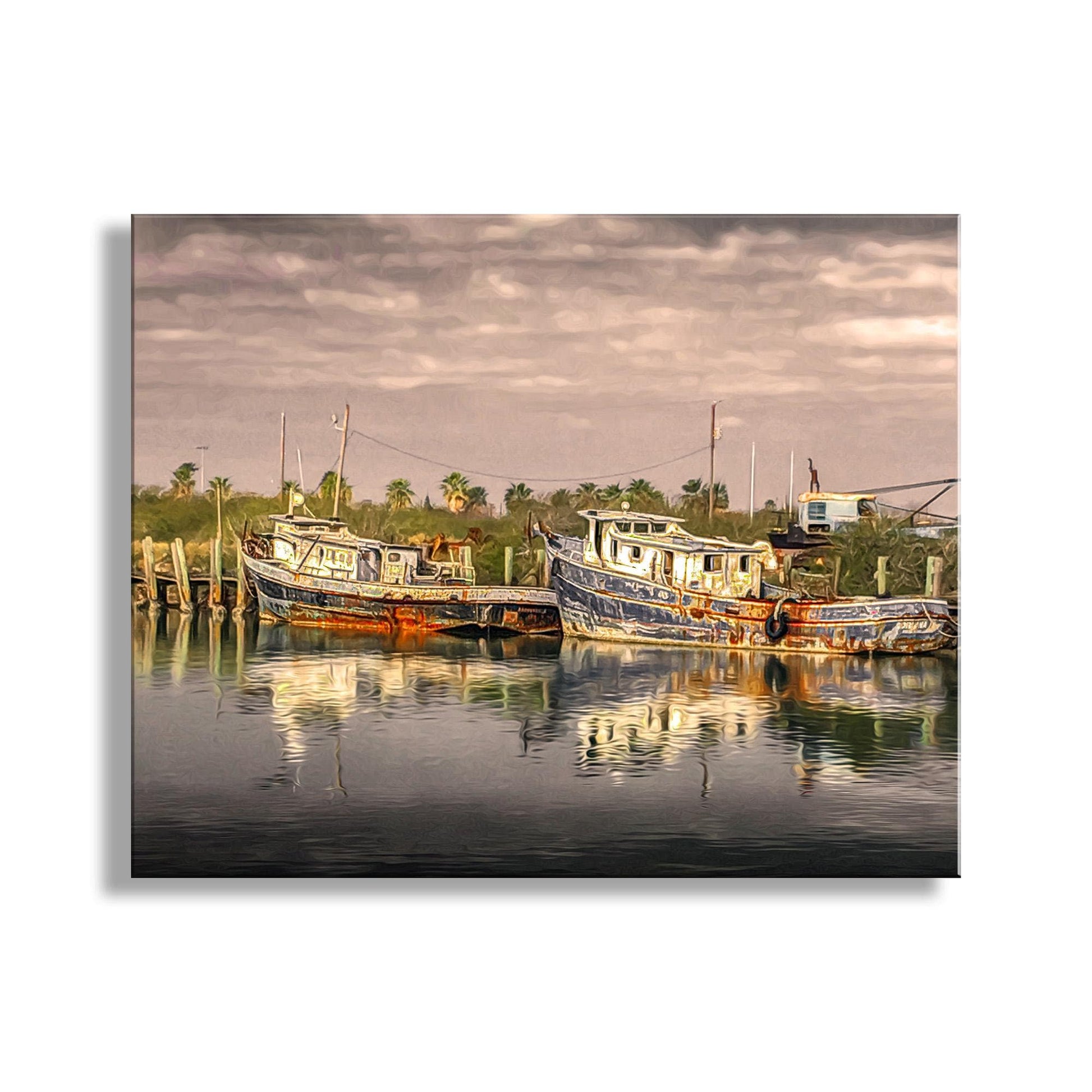 a serene harbor scene with two boats docked in the calm water, surrounded by lush greenery and a cloudy sky. South Padre Island Shrimp Boat Art – Vintage Nautical Print Texas