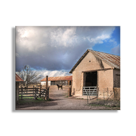 Rustic barn with a horse in a fenced area under a blue sky with clouds. Vintage Ranch Photography with Old Adobe Barn & Horse at Empire Ranch Sonoita Arizona