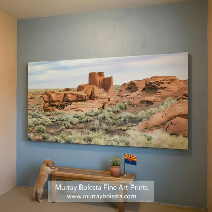 Red rock formation with a small building in a desert landscape. Wupatki national monument by Murray Bolesta