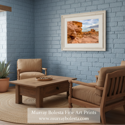 Desert landscape with rock formations and a cloudy sky. Wupatki Pueblo Ruins Print - Arizona Native American Landscape by Murray Bolesta