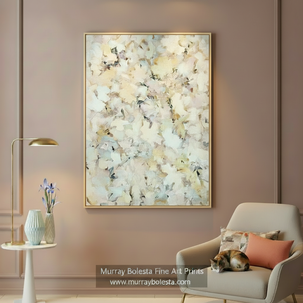 An abstract framed wall art print hangs in a styled living room setting. The artwork features textured, layered brushstrokes in cream, beige, white, and soft gray tones, enclosed in a thin gold frame. by Murray Bolesta