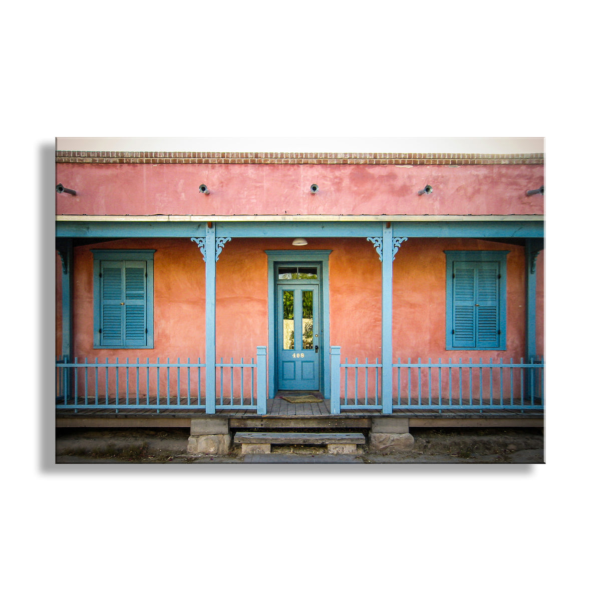 Colorful building facade with a blue door and shutters on a white background. Tucson Barrio Wall Decor for Home with Southwest Architecture and Vintage Adobe