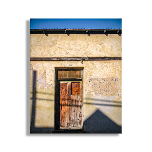 Old building with a wooden door and peeling paint on a white background. Barrio Tucson Arizona Door Print as Southwest Style Wall Decor
