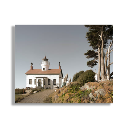 Lighthouse on a hill with trees and rocks in the foreground. Battery Point Crescent City California Lighthouse Art Print