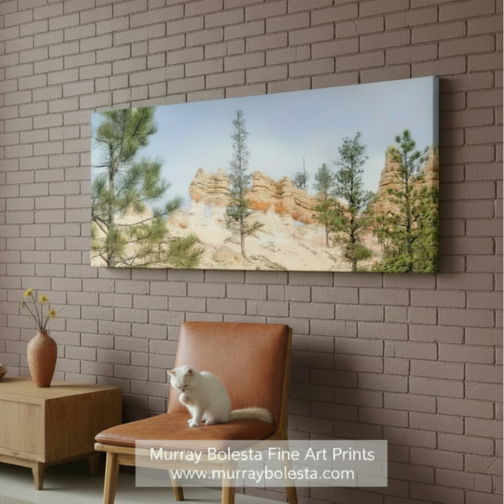 Panoramic view of red rock formations with trees against a blue sky. Utah Landscape Art with Bryce Canyon Panorama by Murray Bolesta