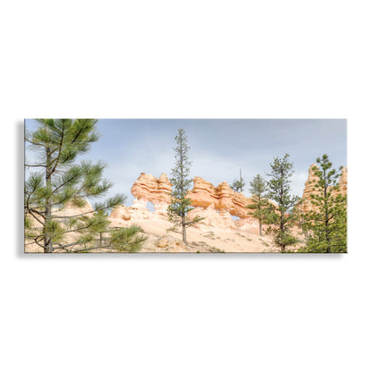Panoramic view of red rock formations with trees against a blue sky. Utah Landscape Art with Bryce Canyon Panorama