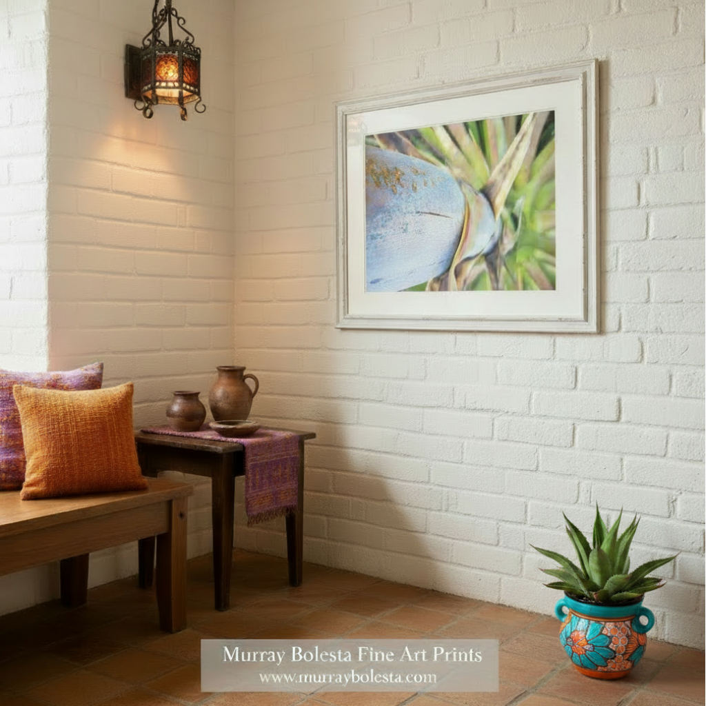 Close-up of a blue and gold object with green plant-like structures in the background. Blue Agave Century Plant Photo – Southwestern Wall Art Print | Desert Succulent Décor by Murray Bolesta
