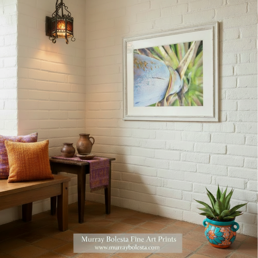 Close-up of a blue and gold object with green plant-like structures in the background. Blue Agave Century Plant Photo – Southwestern Wall Art Print | Desert Succulent Décor by Murray Bolesta