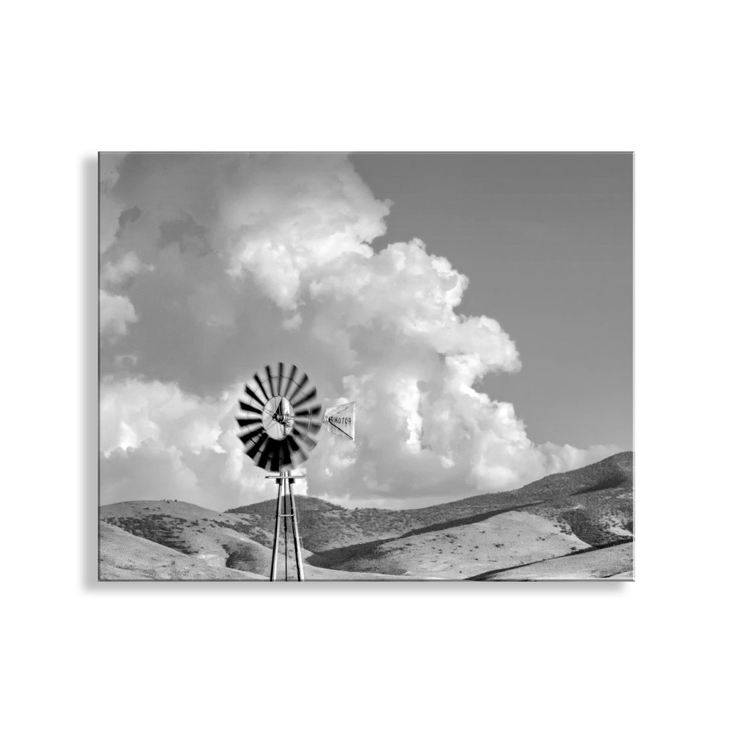 Black and white windmill against a dramatic sky with clouds. Black & White Arizona Ranch Windmill Photograph as Western Style Wall Art