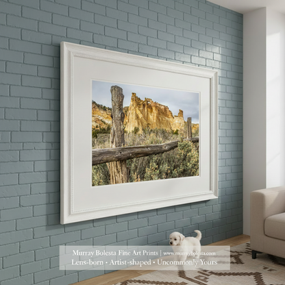 Scenic landscape with a wooden fence, rocky cliffs, and desert vegetation. Grosvenor Arch Southern Utah Landscape Art Print as Desert Wall Decor by Murray Bolesta