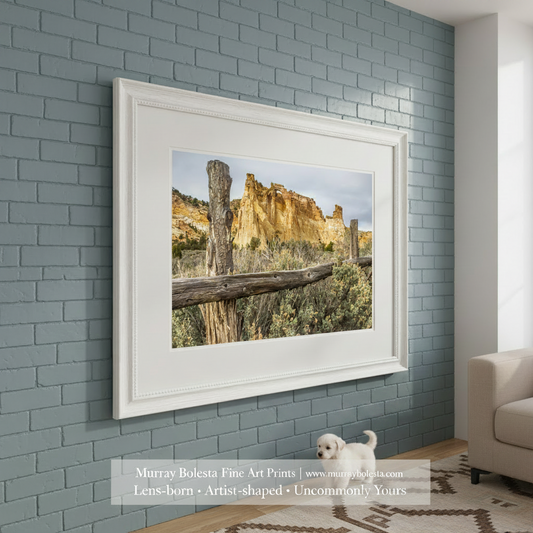 Scenic landscape with a wooden fence, rocky cliffs, and desert vegetation. Grosvenor Arch Southern Utah Landscape Art Print as Desert Wall Decor by Murray Bolesta