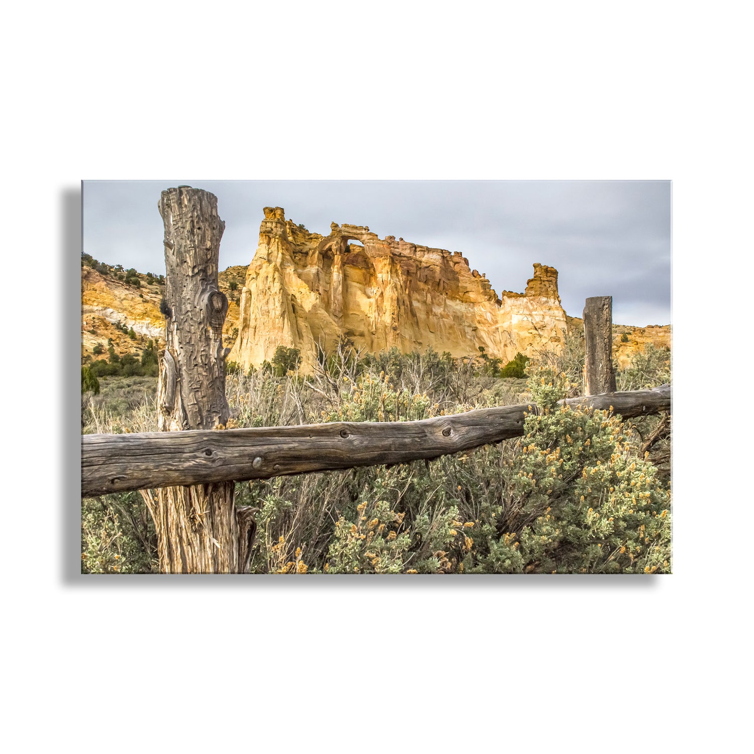 Scenic landscape with a wooden fence, rocky cliffs, and desert vegetation. Grosvenor Arch Southern Utah Landscape Art Print as Desert Wall Decor