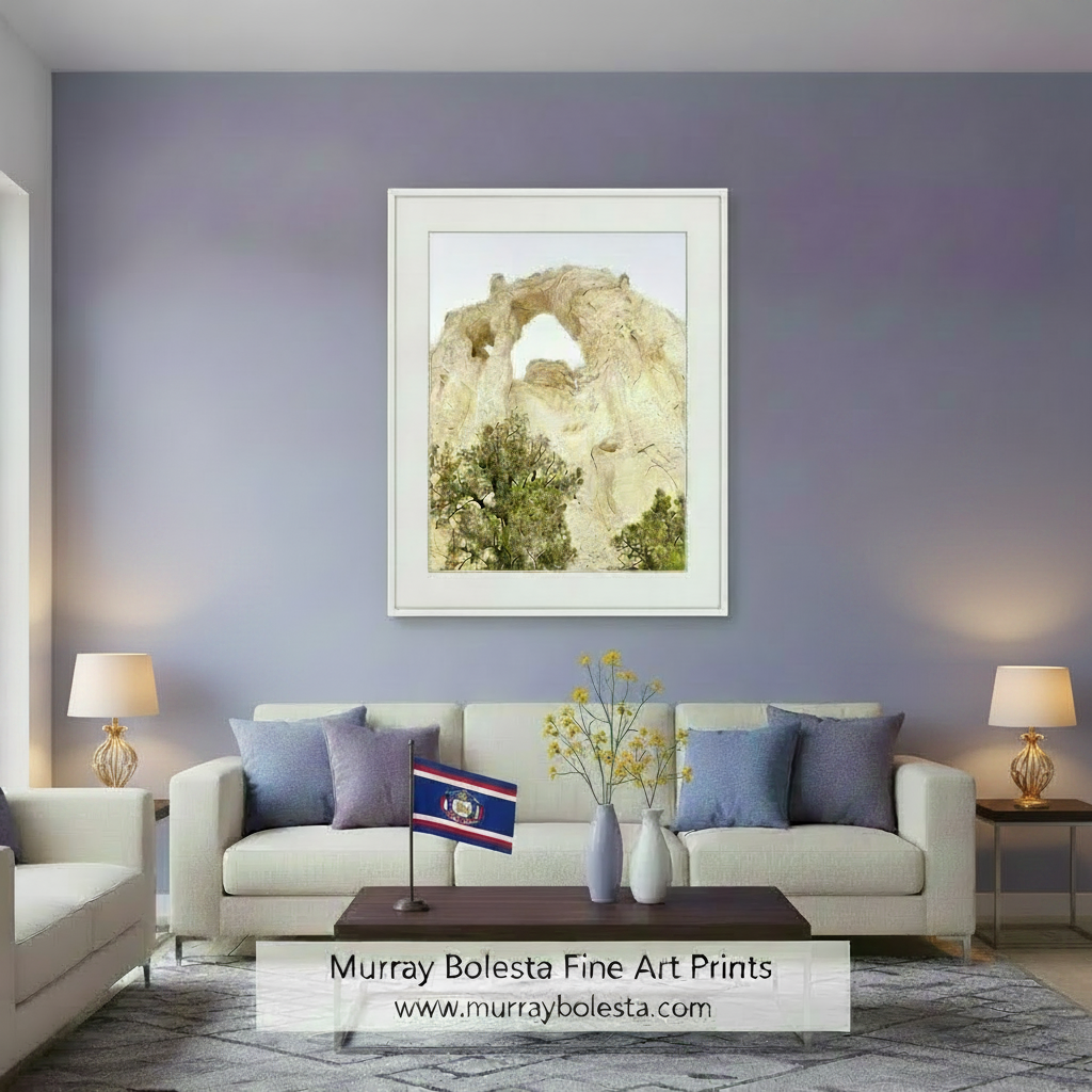 a large rock formation with a natural arch, surrounded by trees and shrubs. Grosvenor Arch Utah Desert Landscape Art Print by Murray Bolesta