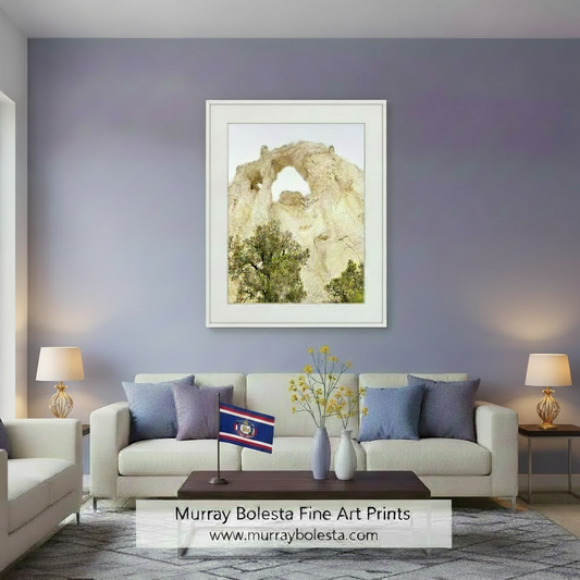 a large rock formation with a natural arch, surrounded by trees and shrubs. Grosvenor Arch Utah Desert Landscape Art Print by Murray Bolesta