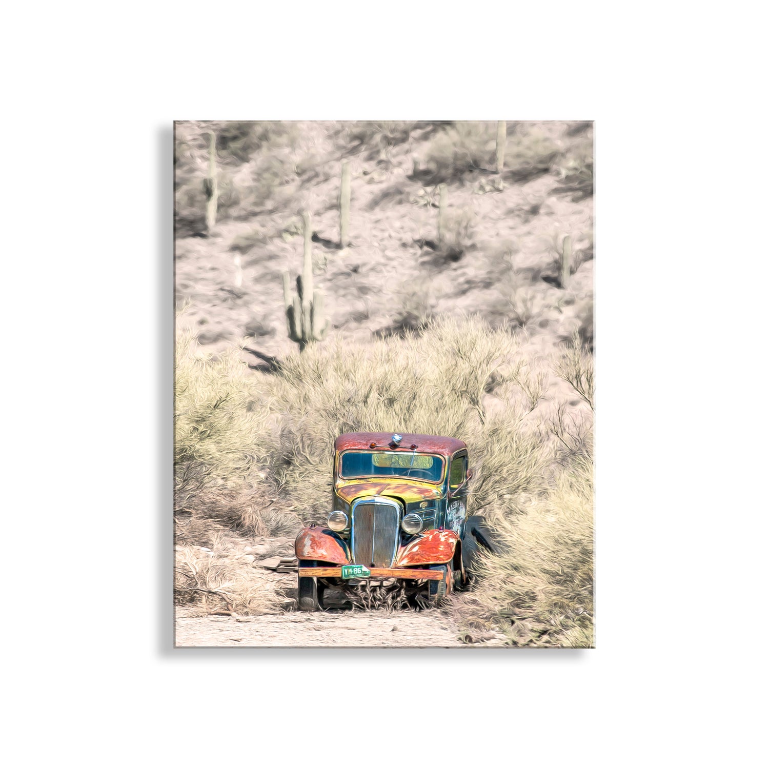An old, rusted car is parked on a dirt road in a desert-like environment, surrounded by tall, dry grass and cacti. Vintage Truck in Arizona Desert - Rustic Southwest Photography