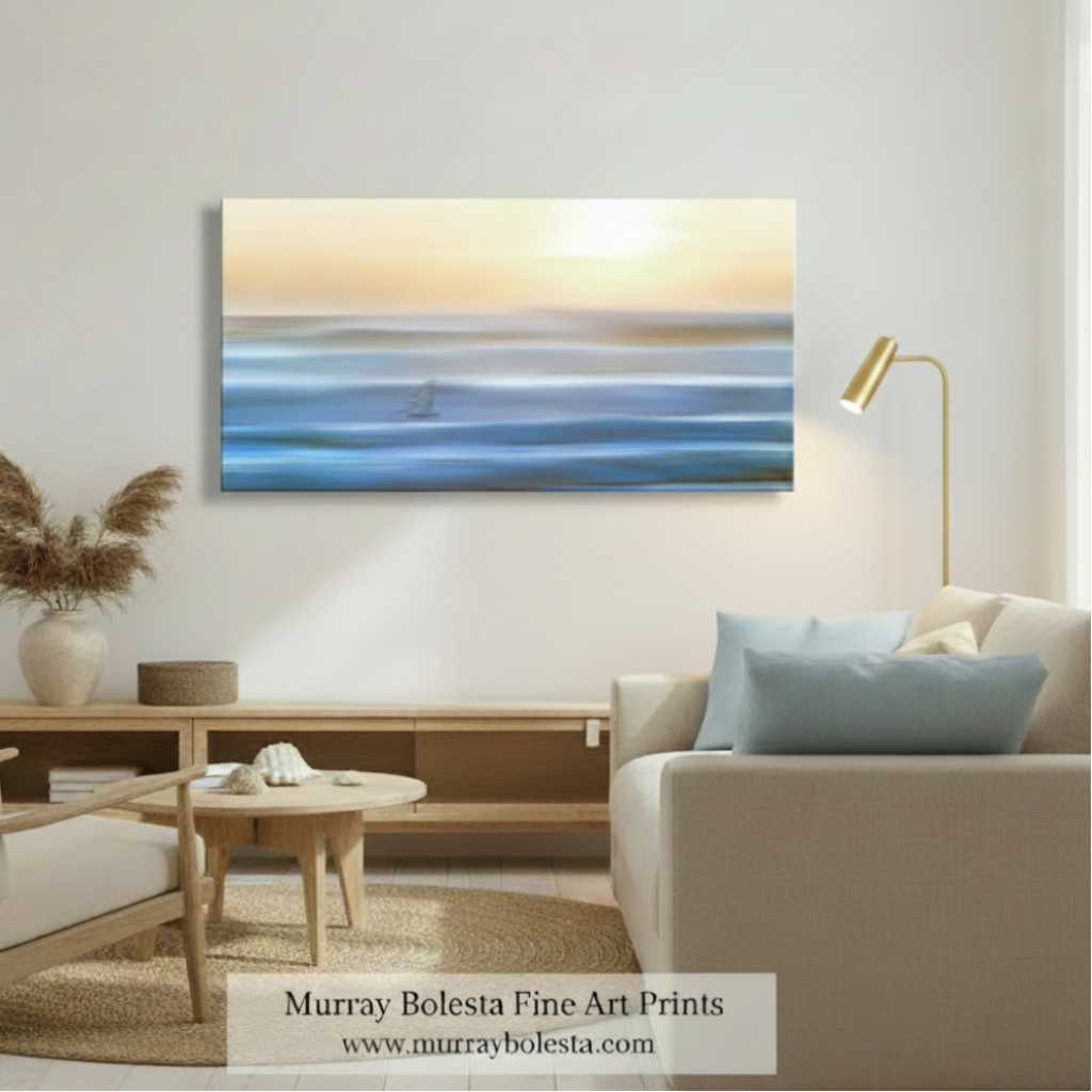 A horizontal canvas art print depicting an abstract ocean sunset with blue waves and a glowing sun, displayed on a wall in a modern, neutral-toned living room setting. A watermark at the bottom reads 'Murray Bolesta Fine Art Prints'.