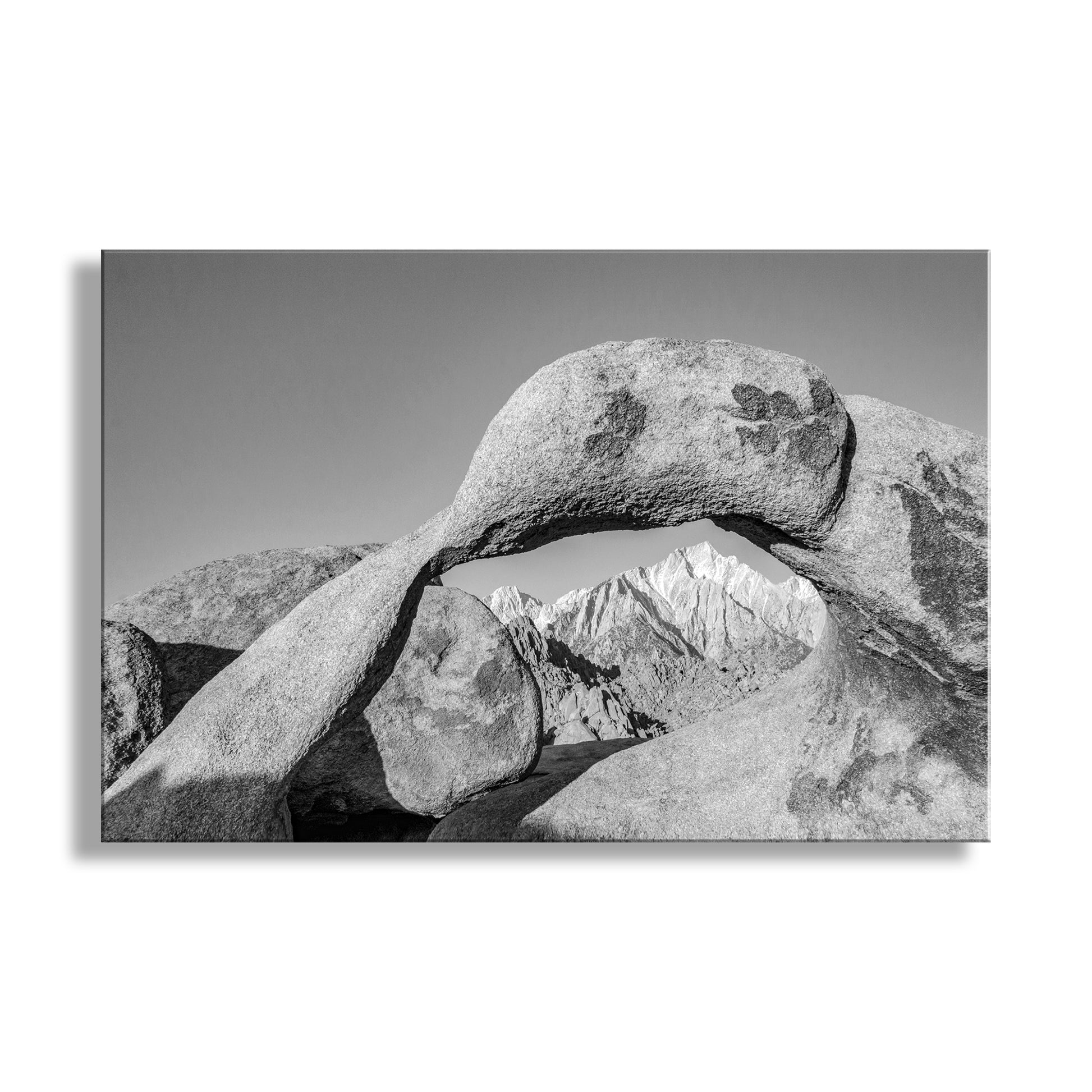 Black and white photo of a natural stone archway with mountains in the background. Alabama Hills Photograph as California Desert Western Landscape Wall Art in Black and White