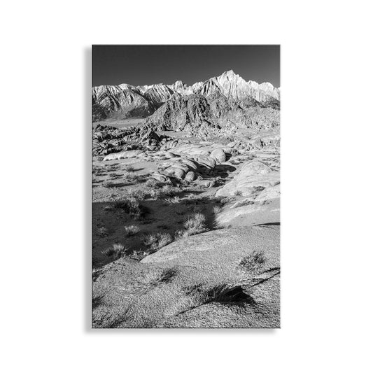 Black and white landscape of a desert valley with mountains in the background