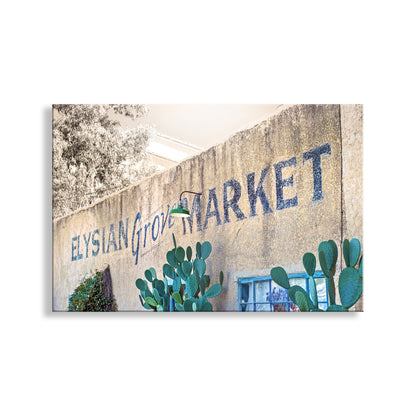Elysian Grove Market sign on a stone wall with cacti in front.  My terrific Tucson Barrio Viejo architecture art to embellish your walls! This precious place is near the Santa Cruz River and was once a watery haven. Wonderful southwestern heritage! Original, unique signed art by Murray Bolesta.