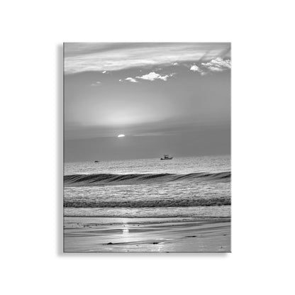 Black and white landscape with a boat on the water and a cloudy sky. My spectacular ocean photography sunrise art print from Rhode Island USA! A lone fisherman plies the placid waters. Original, unique signed art by Murray Bolesta.