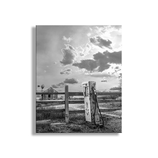 Vintage gas pump near a wooden fence with a barn and cloudy sky in the background. Vintage Gas Pump & Ranch Corral at Empire Ranch Sonoita Arizona in Black & White