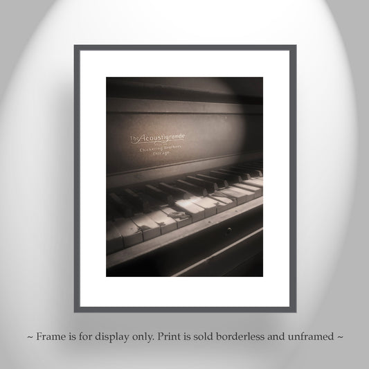 Framed print of a piano keyboard with 'The Acoustigrande' branding on a gray background. Chickering Piano Surreal Art from Ruby Arizona Ghost Town