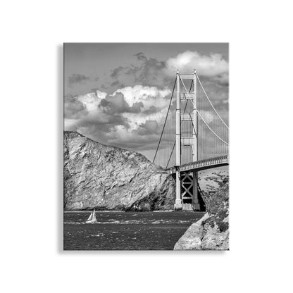 Black and white image of the Golden Gate Bridge with a sailboat in the foreground.  My great Golden Gate Bridge sailing photograph in black &amp; white! This colossal 1937 structure, with Marin County in the background, is symbolic of so much of American history and aspirations, and is a vision of grace in steel. Original, unique signed art by Murray Bolesta!