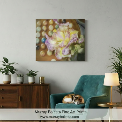 A framed wall art print featuring a soft-focus floral painting with pastel purple, yellow, and peach tones, displayed above a teal armchair in a styled living room. The print is the product being sold, and the room serves as a lifestyle mockup context. by Murray Bolesta