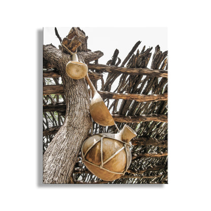 Decorative wall art with wooden elements on a textured background. Rustic Gourd Art with Ocotillo Ramada | Southwestern Design at Tumacacori Mission Arizona