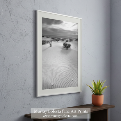 A black and white photograph depicting a vast, undulating sand dune landscape with sparse vegetation. Desert Sand Dune Minimalist Landscape - White Sands New Mexico Art by Murray Bolesta
