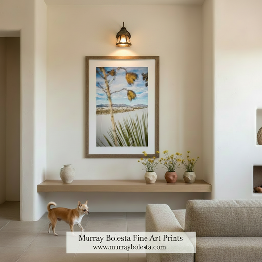 a desert landscape with a tall, thin tree branch in the foreground and a distant mountain range in the background. Yucca Agave Plant Print - White Sands New Mexico Desert Landscape Art by Murray Bolesta