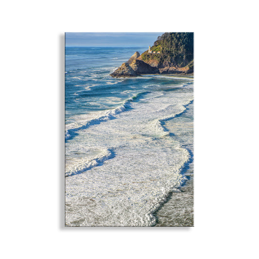Coastal scene with waves crashing onto a rocky shore and a lighthouse in the distance. My outstanding Oregon, USA, seacoast picture at Heceta Head!