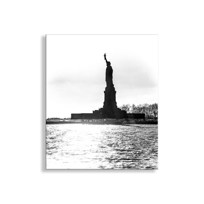 Black and white silhouette of the Statue of Liberty against a cloudy sky. Statue of Liberty Black & White New York City Wall Art Print